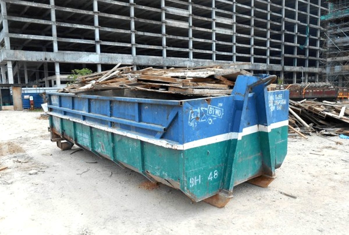 Cascadia Waste & Roll-Off Services commercial roll-off delivery with wooden driveway protection boards