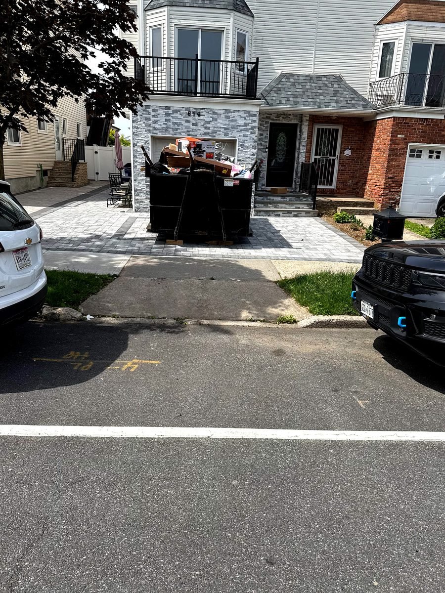 Driveway protection boards placed under dumpster rollers