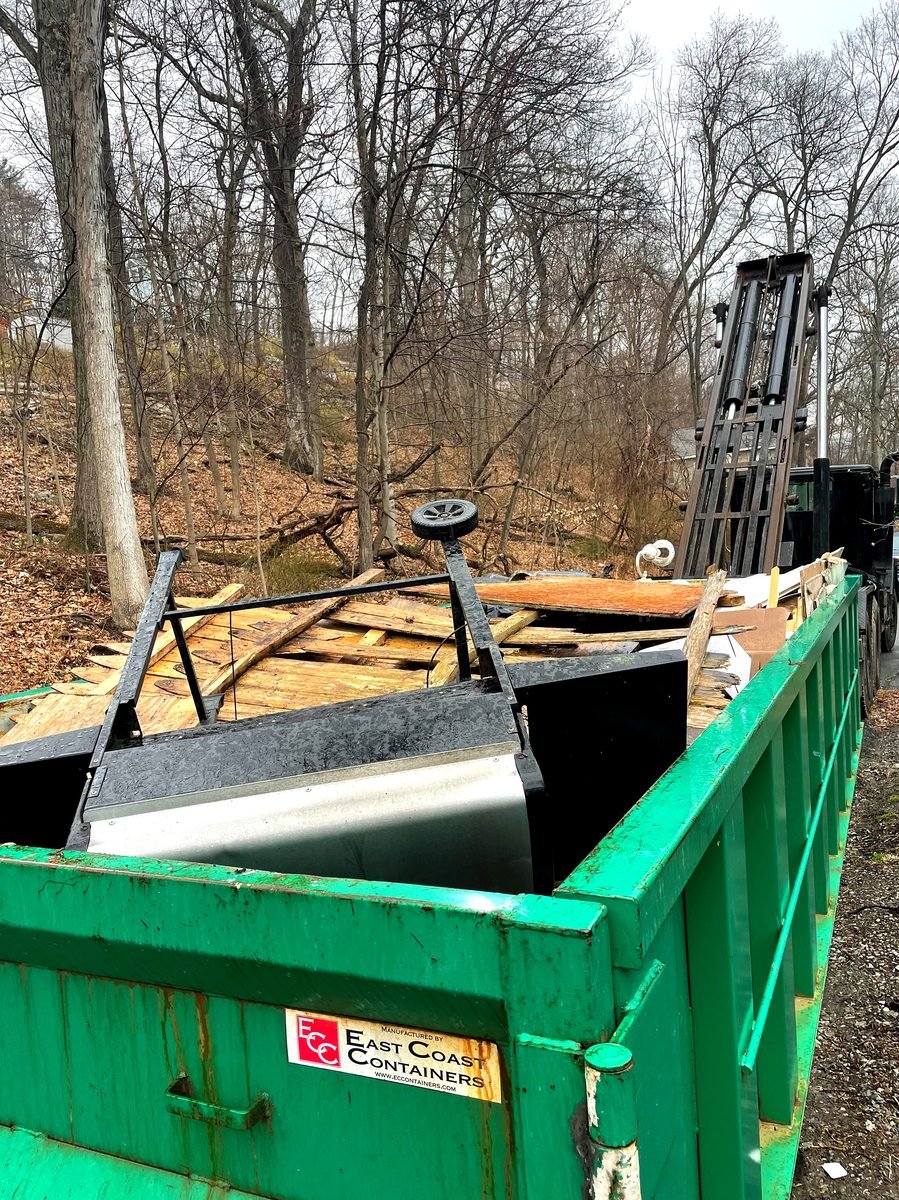 Commercial roll-off container on asphalt