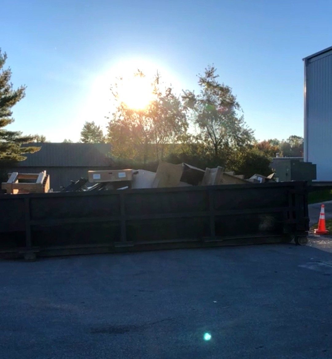 Winch truck loading construction dumpster