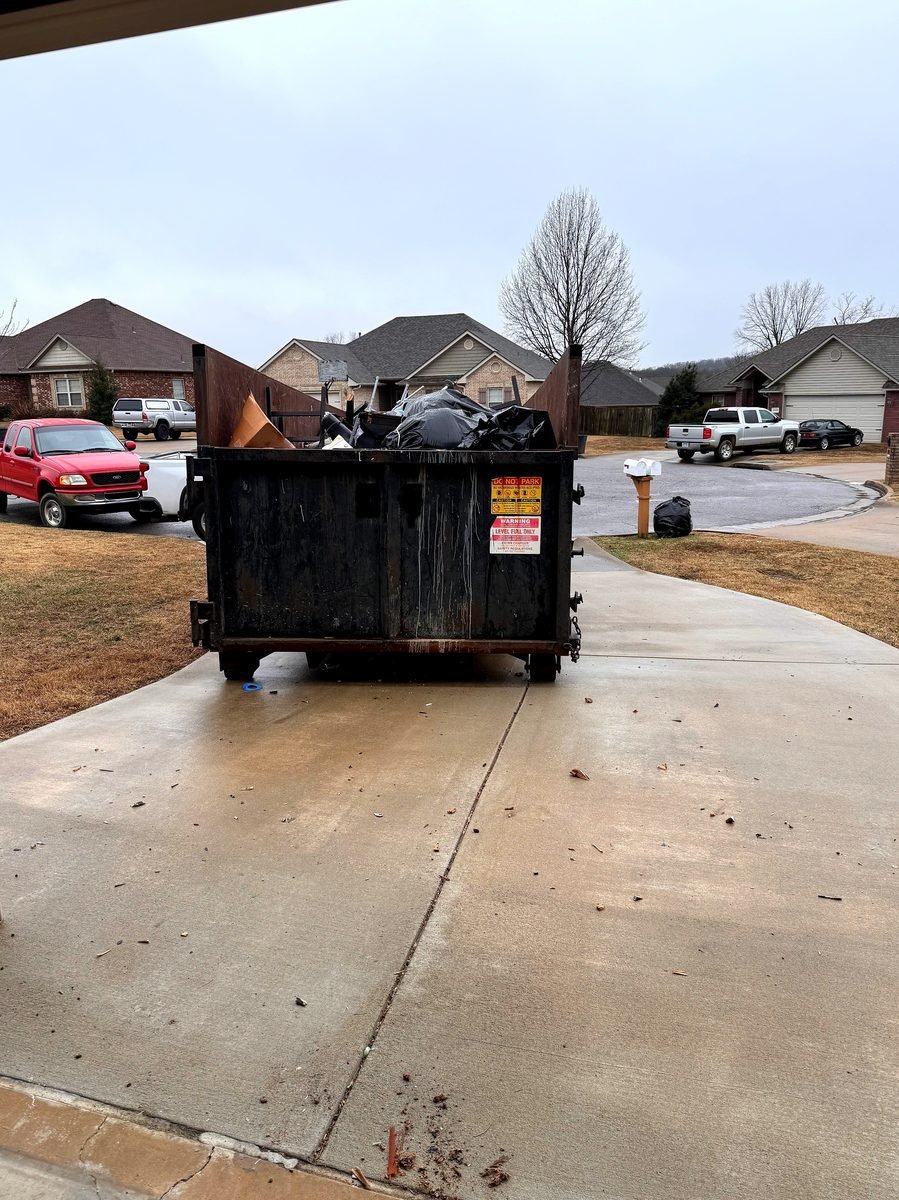 Bluff City Waste & Roll-Off Services roll-off delivery truck and driver operating in Memphis