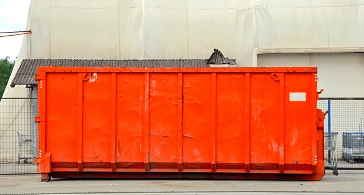 Smoky Mountain Waste & Roll-Off Services roll-off container delivery on residential driveway in Knoxville