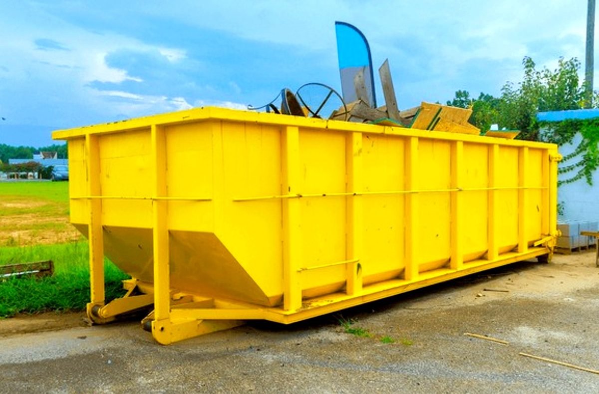 Midland Waste Logistics & Roll-Off Services roll-off container delivery on residential driveway in Kansas City