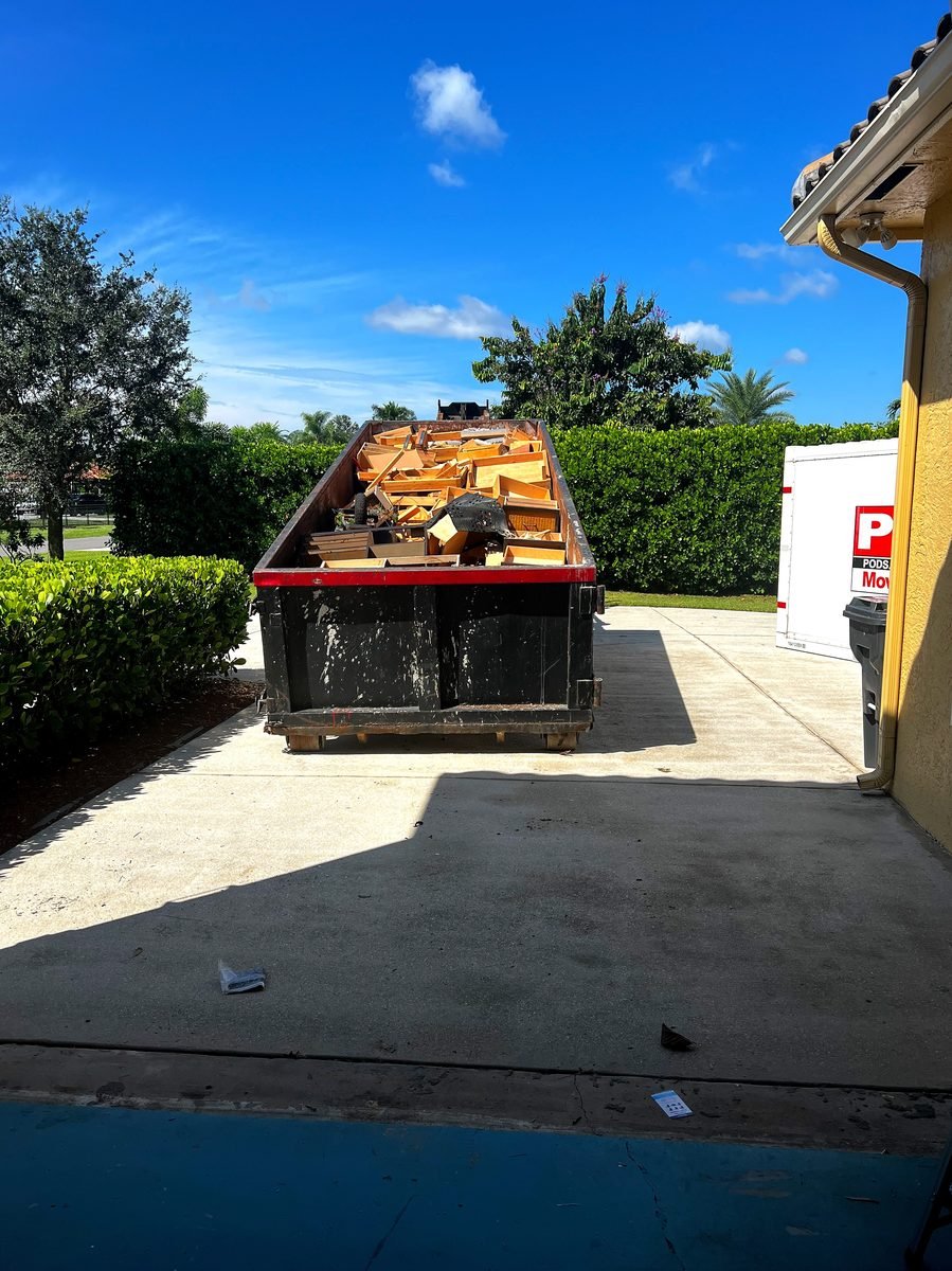 Tennessee Valley Waste & Container Services roll-off container delivery on residential driveway in Huntsville