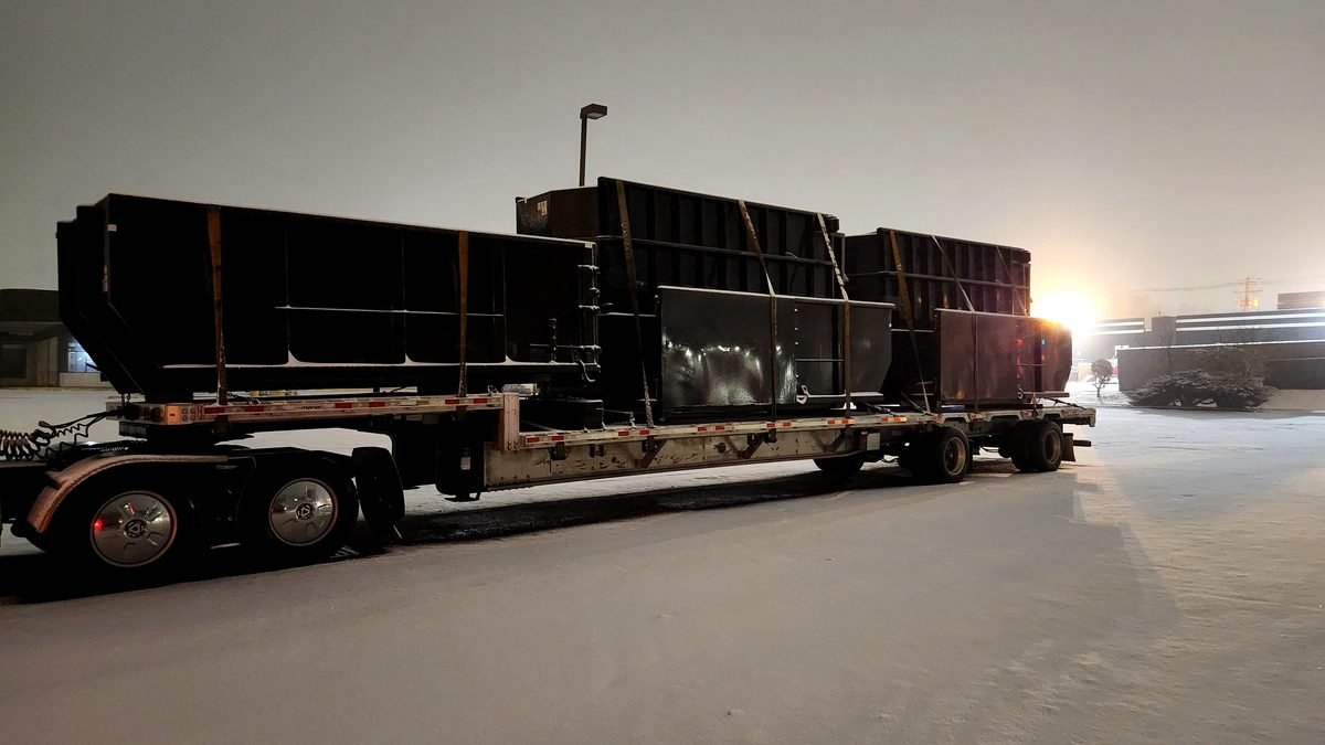 Desert Valley Waste & Roll-Off Services roll-off delivery truck and driver operating in Las Vegas